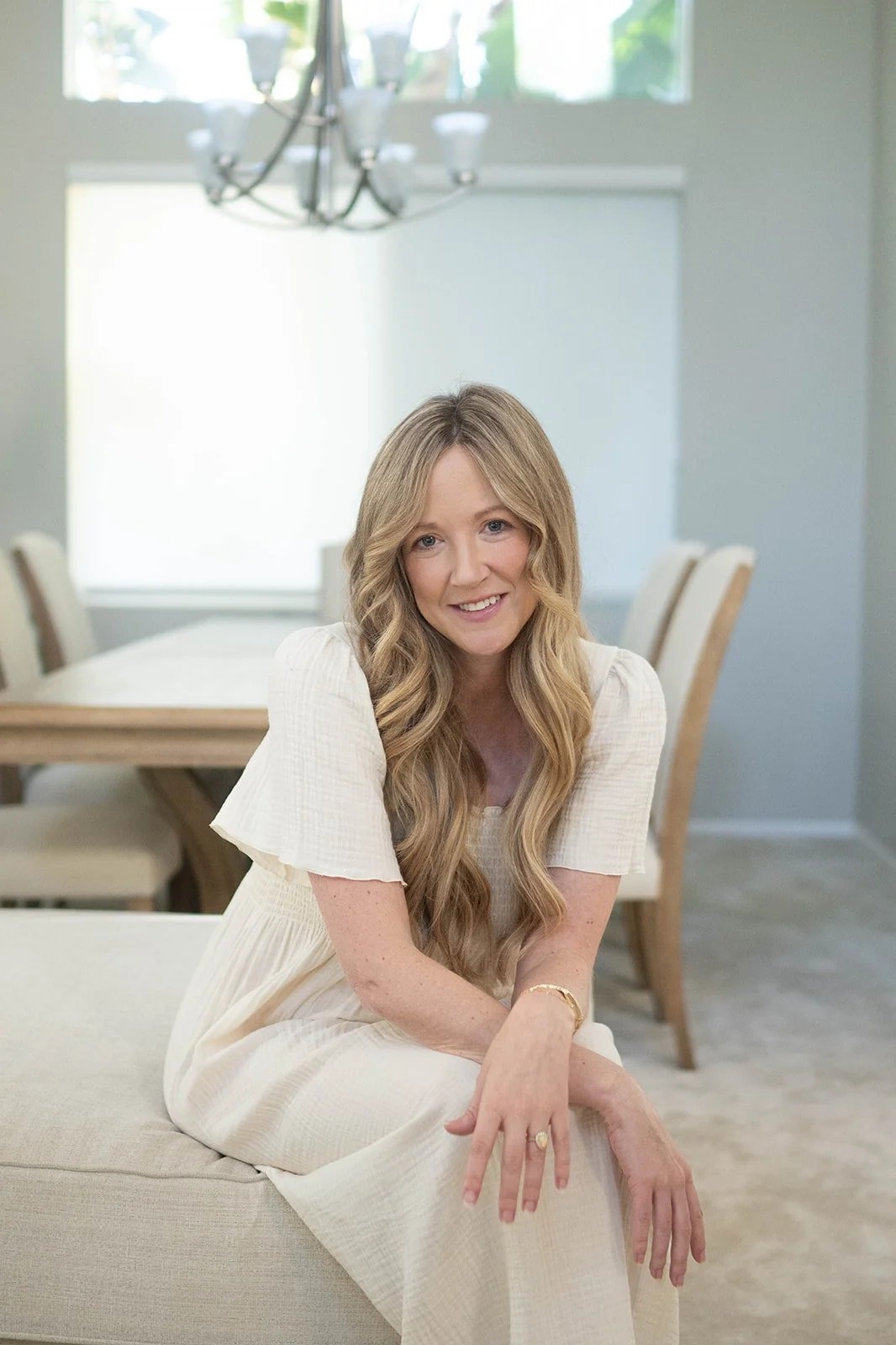 Woman sitting at desk learning crypto trading on laptop, taking notes as a beginner trader in 2026